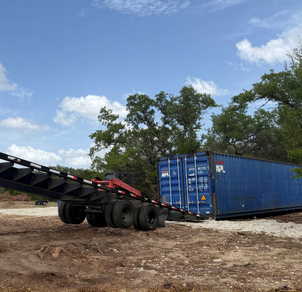 40ft container trailer dropping off a blue container