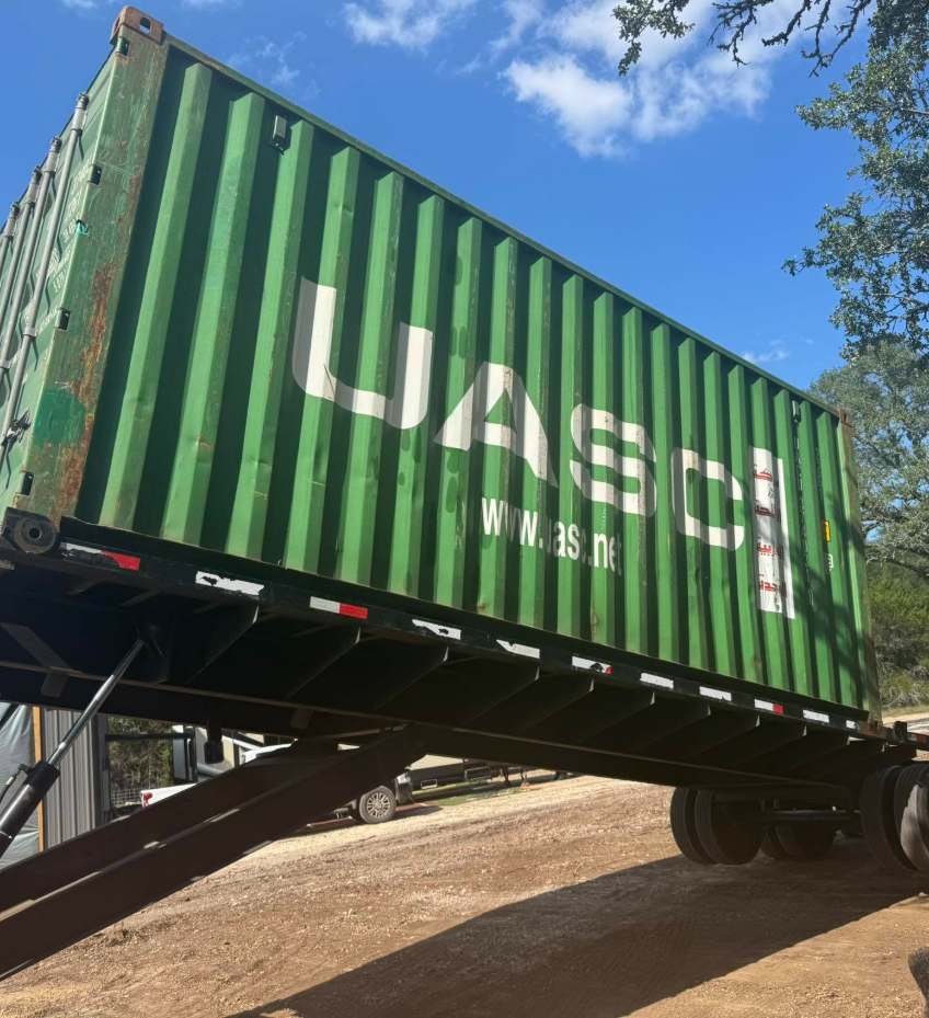 green storage container on an inclined trailer