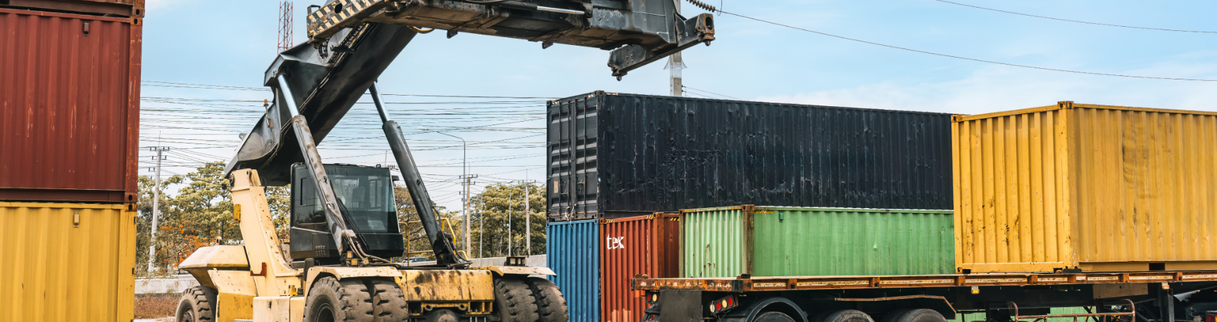 yellow lifter machine in storage container yard