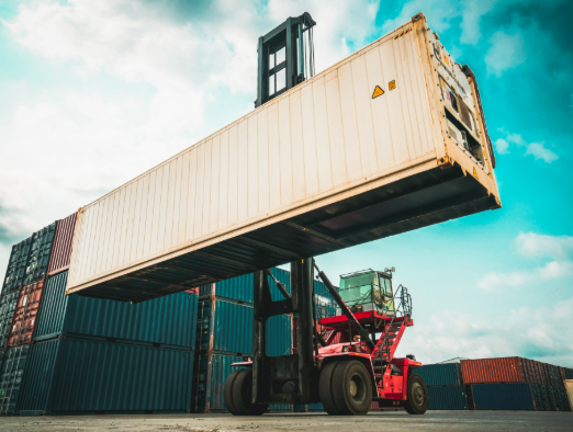 red container lifter lifting tan storage container